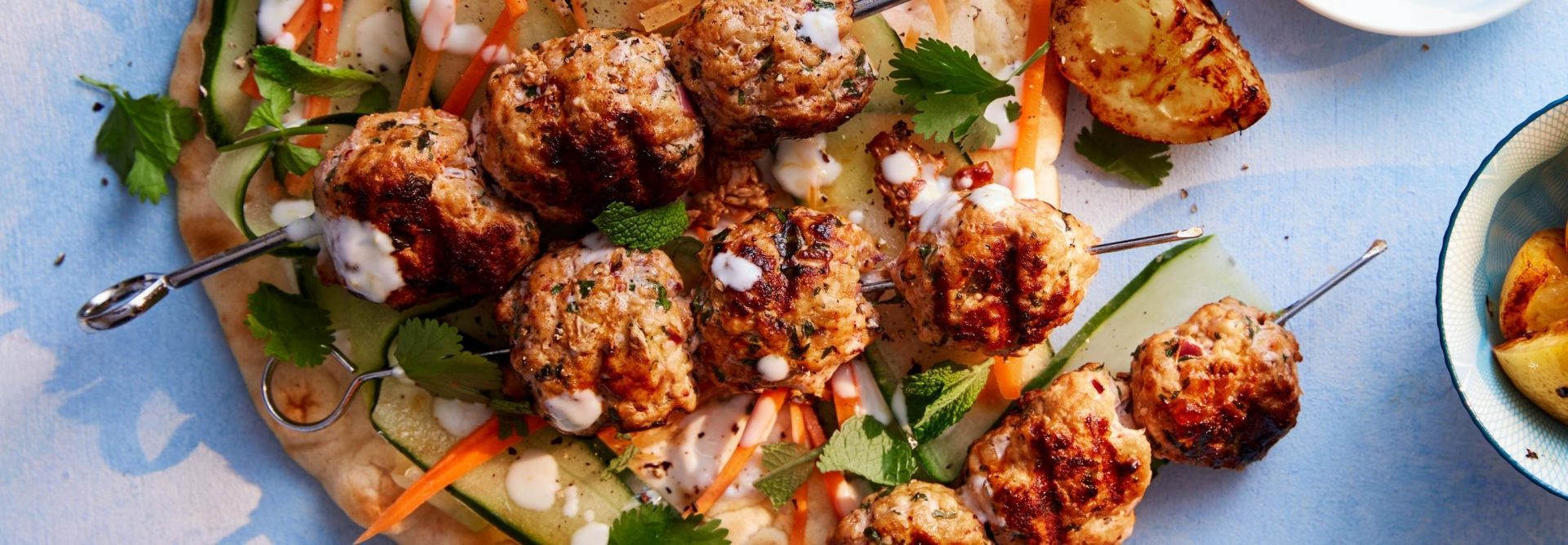 Pork meatball skewers on a single flatbread
