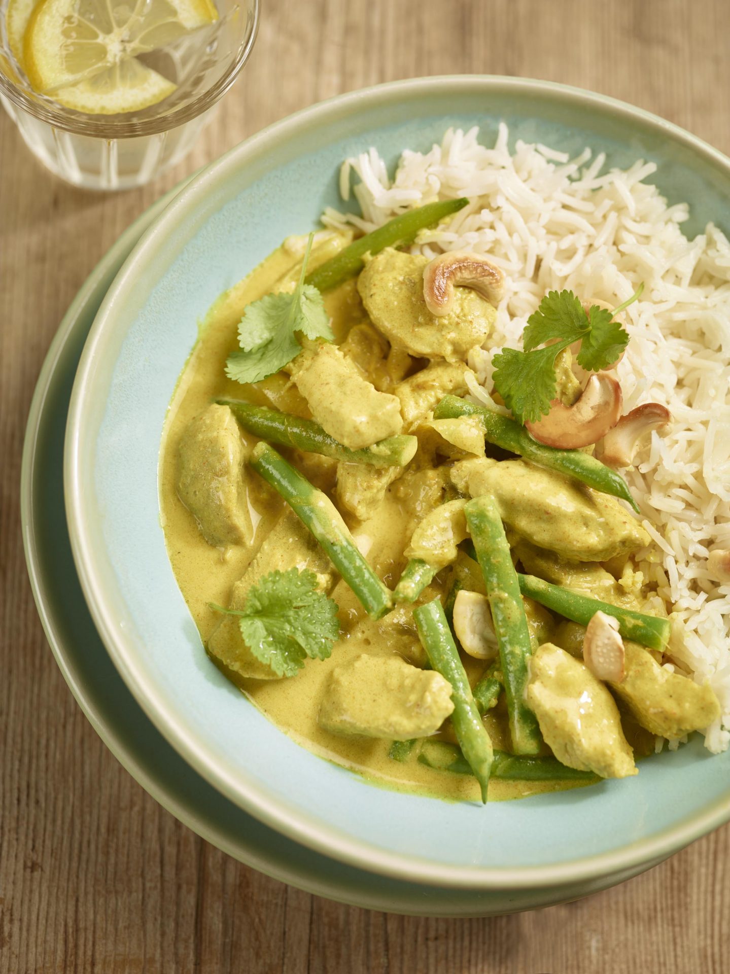 Pork curry with white rice served in a blue bowl