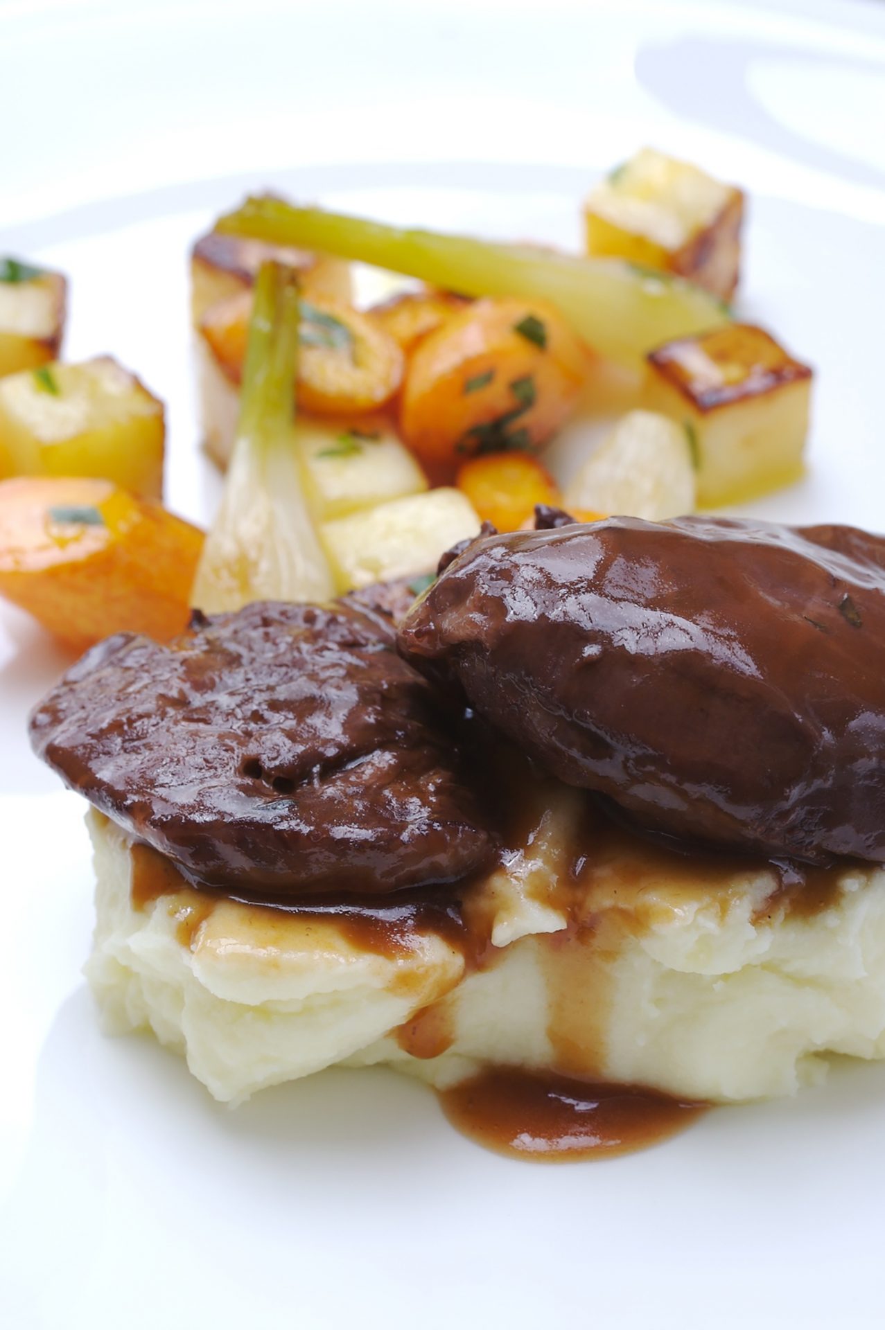Elderflower braised pork cheeks on top of mash