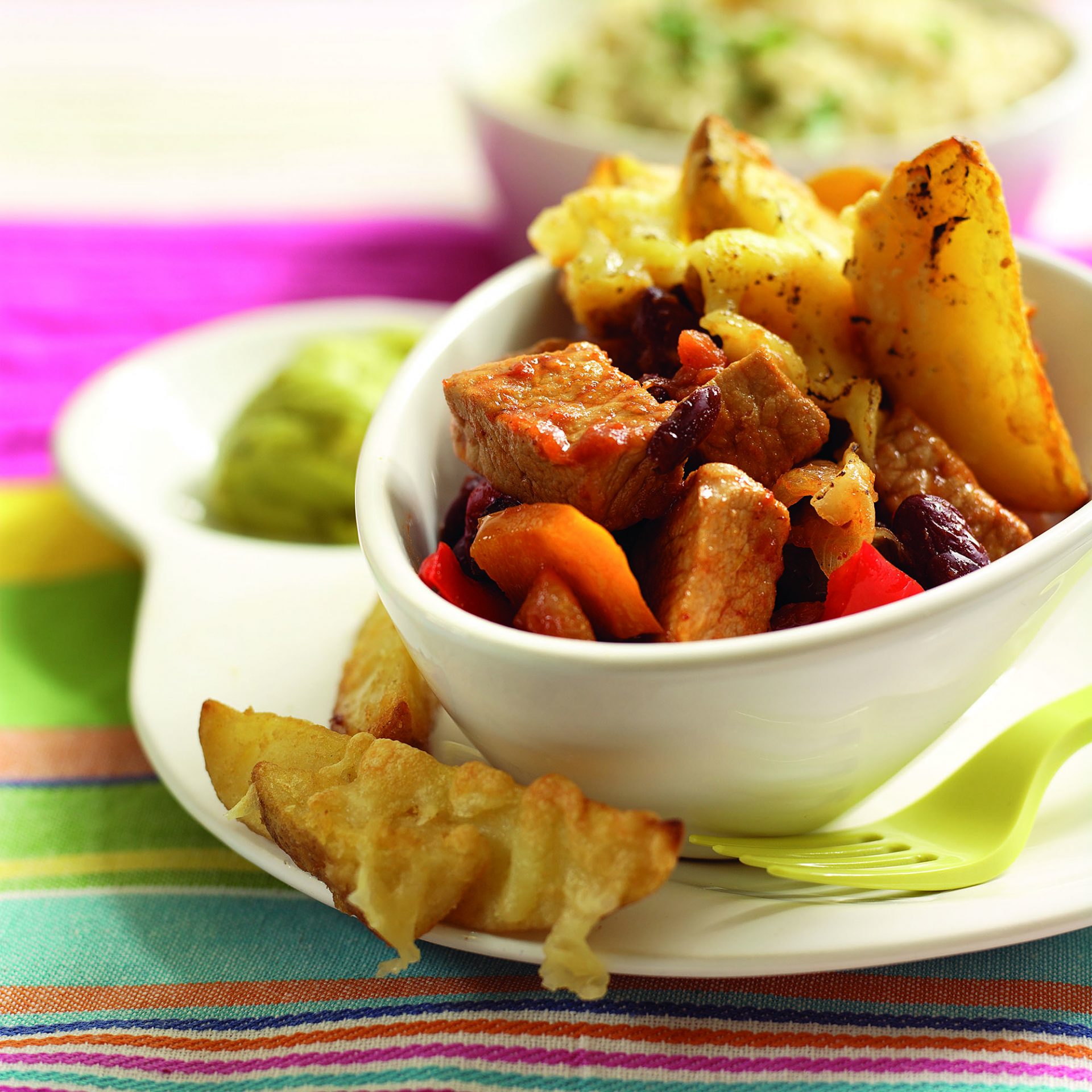Mexican pork with garlic and kidney beans in a white bowl.