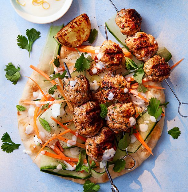 Pork meatball skewers on a single flatbread