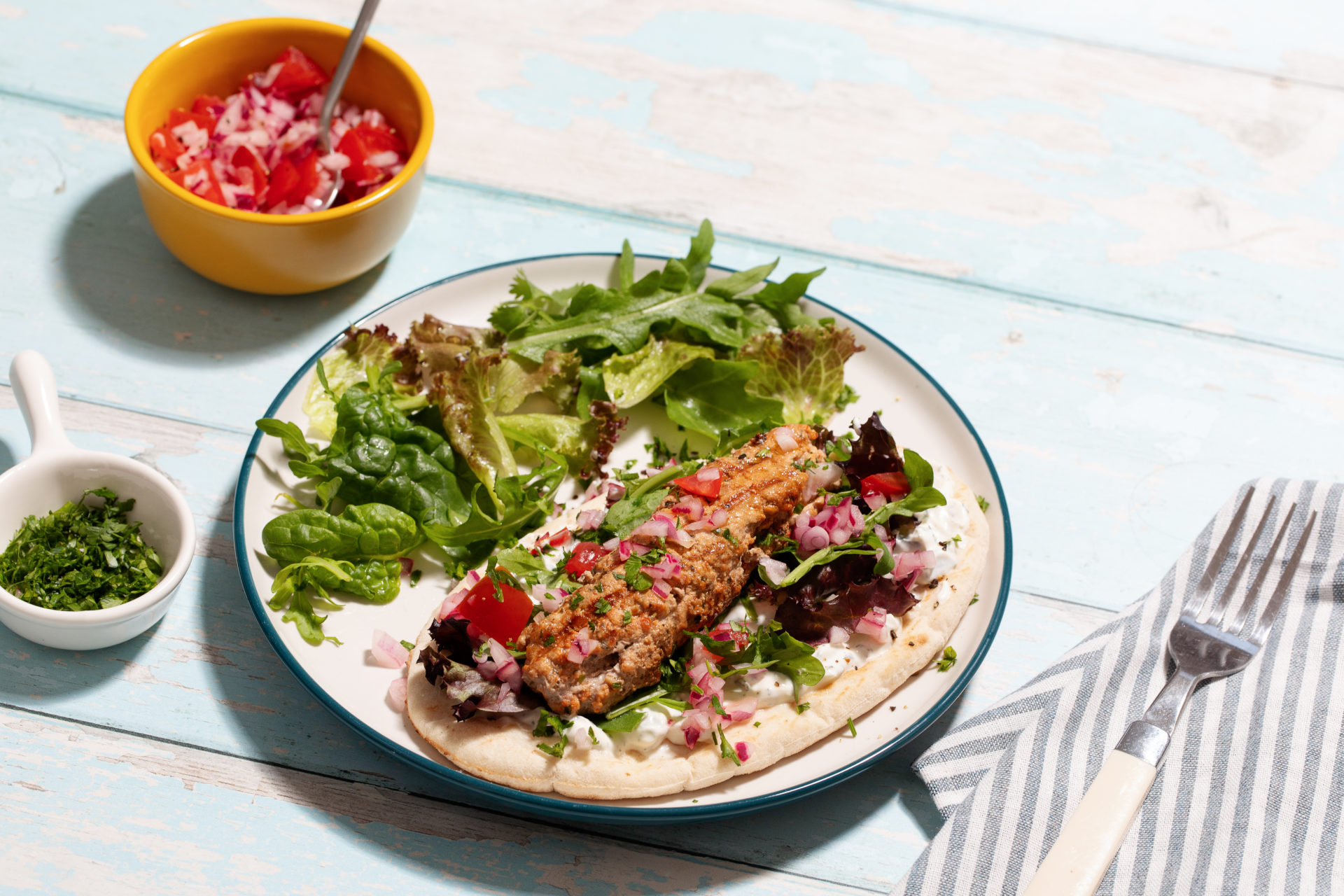 A plate of Pork Mince Koftas with Pitta and Tzatziki