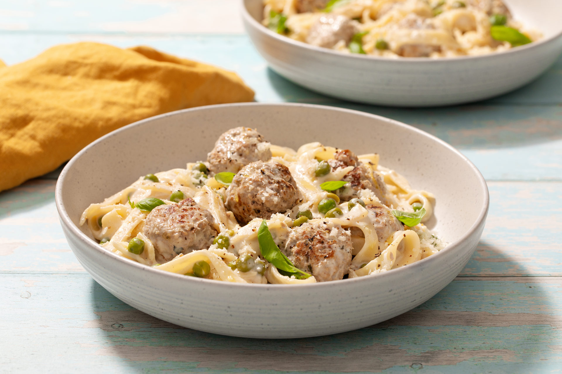 Bowl of Creamy lemon pasta with pork mince meatballs.